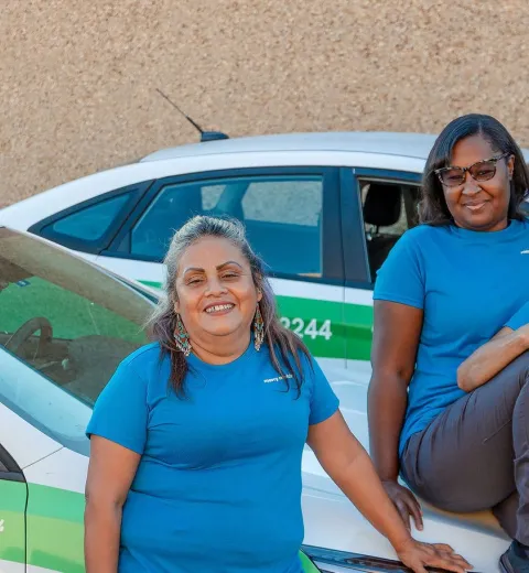 merry maids posing by branded vehicles